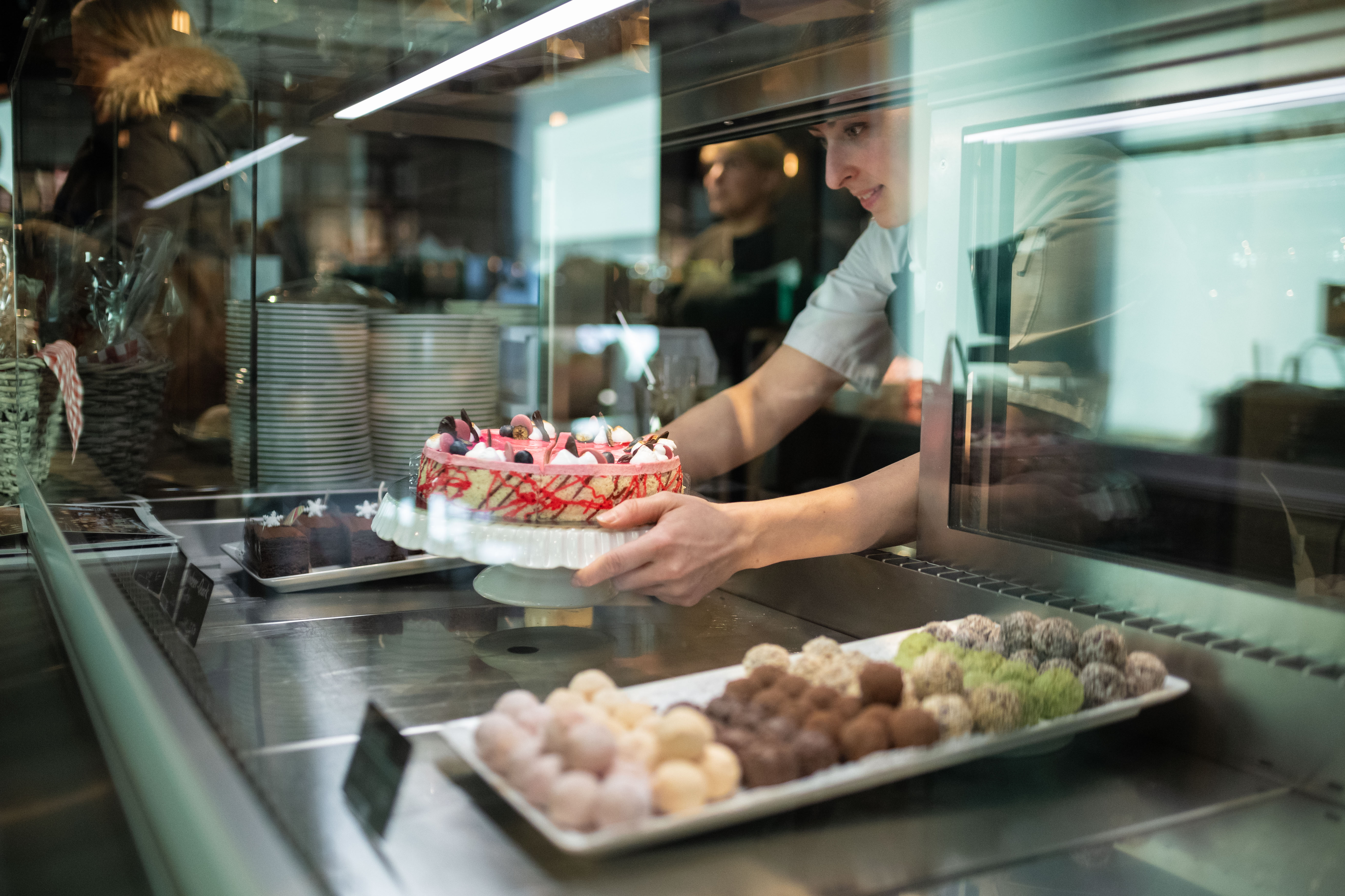 Display case with a selection of housemade pralines and cakes